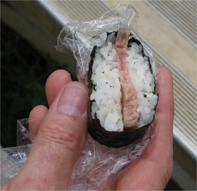 Robert holding his musubi at the Hilo drag races. Musubi is basically sushi except there is SPAM in place of fish, and the rice is treated slightly differently. This cheap meat is a local favorite. Hilo, HI. June 2009.