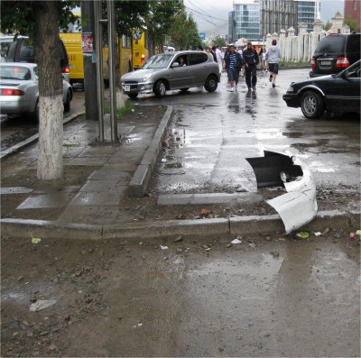 In one of those rare did-that-really-just-happen moments, an angry drunk driver was raging down the sidewalk, turning sharply onto the street just feet away from me. He then intentionally rammed into the front of the forward yellow bus and into a car. After that, he moved back onto the sidewalk and sped away as people literally jumped out of the way. Hopefully no one got killed. Afterward, i snapped a picture of his bumper on the sidewalk.
