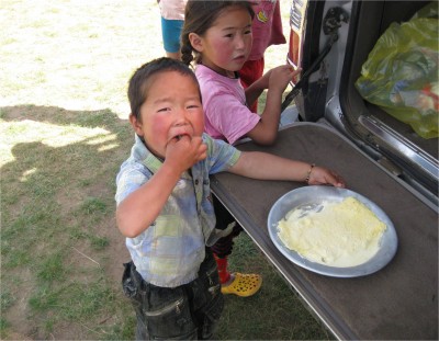 Nomadic families let nothing go to waste. Since their diets consist almost entirely of meat and dairy, they produce multiple products. This tin of dairy cream can be eaten plain, as the boy deminstrates, or put in milk tea as a light sweetener.