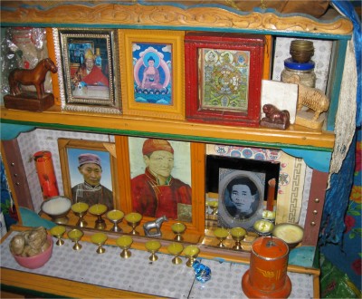An active shrine for a recently-passed relative was inside our ger. A little bit of food from meals is left for the deceased person, and the candles are lit at night. The little blue wrapped candy was part of the offering we took to the family in exchange for letting us stay the night. They left a piece at the shrine.