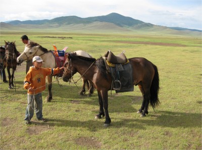 Mongolian horses are small. I took this one for a ride and when I returned, the little boy in orange jumped on him and showed me how to make the horses work. His feet were a foot off the stirrups, he used no crop, and had no fancy gear, but he knew how to handle that animal. All Mongolian children become experts in horses.