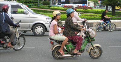 I've seen quite a few scooters carrying three people at a time. Occasionally, a four person scooter will pass. Residents call these machines motorbikes, but I have a hard time calling them anything other than scooters.