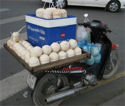 A very common site---scooters act as transportation, lunch benches, makeout locations, and streetvending stands. Less money forces more resourceful spending.