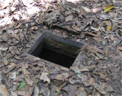 This is a typical tunnel entrance. Notice the camouflaged cover just above the hole. The hole is about the size of a junior high mathematics book.