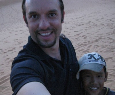 Near the fast growing beach town of Mui Ne are sand dunes. Overly aggressive little kids, like the one in the picture, try to convince tourists to rent little plastic sleds for surfing the sandy slopes. 