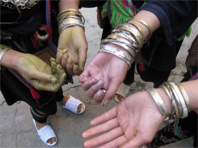 Many H'Mong women selling clothing and jewelry in the mountain villages have hands stained a blue-green color. It comes from the indigo dye used on traditional clothing.