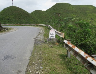 All of Vietnam's distance roadsigns, from Phu Quoc Island to Sa Pa, look like this one. They are stone tablets, mostly with weathered paintjobs, on the side of the road.